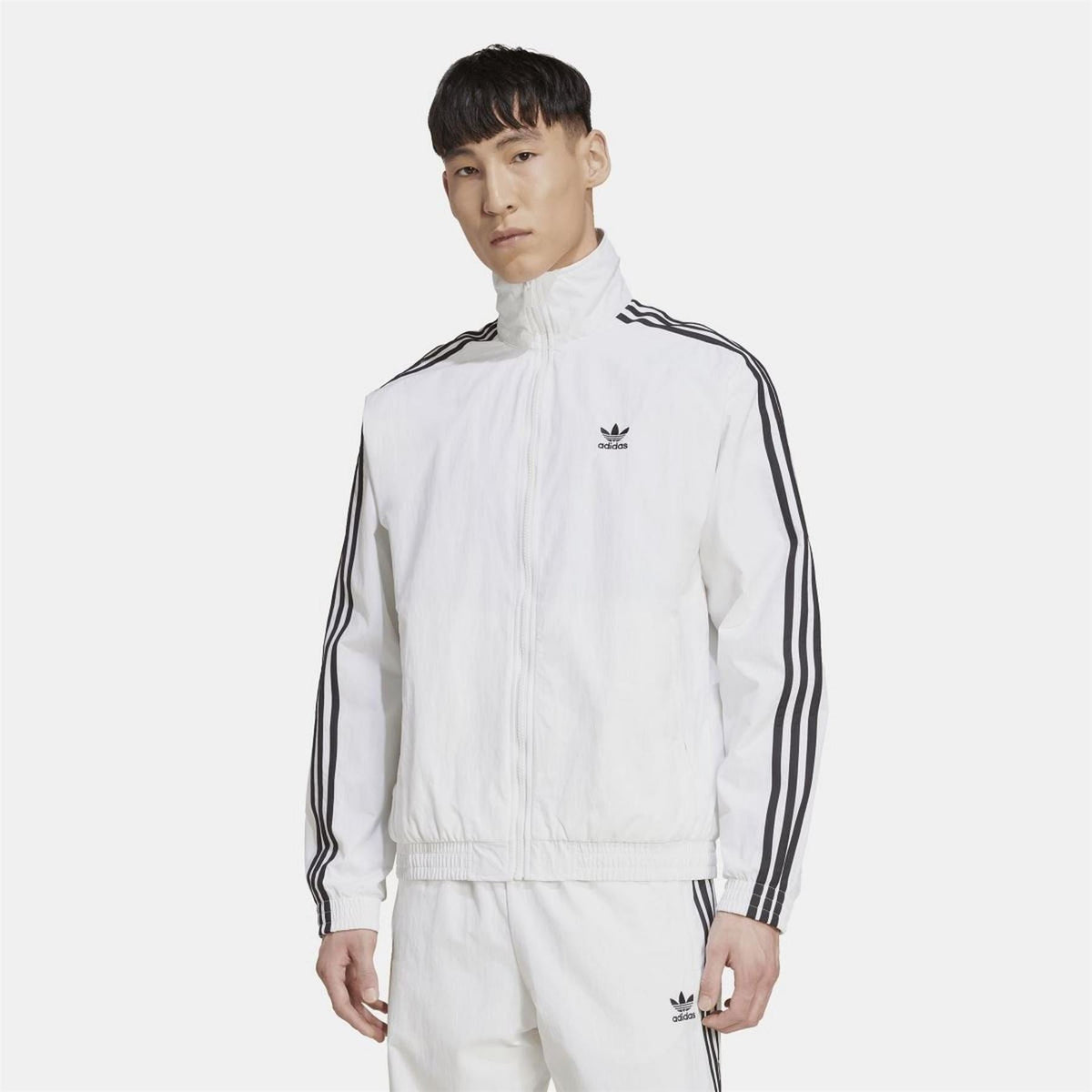 White track top with stand collar, full zip, and adidas logo with black sleeve stripes