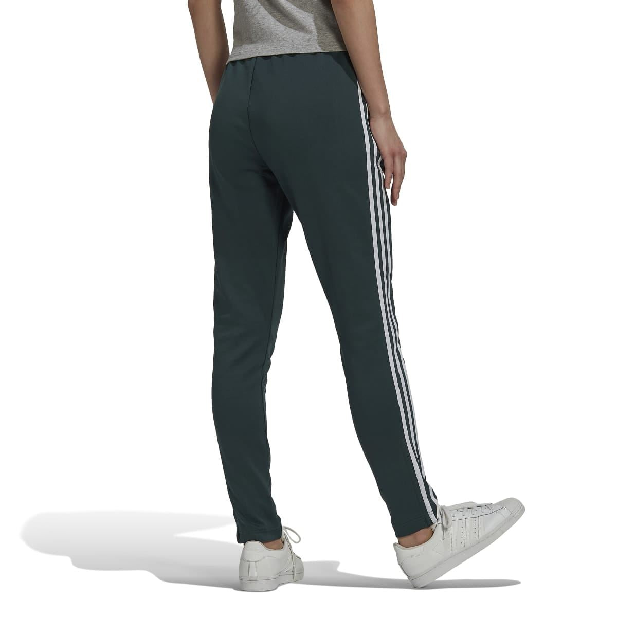 Dark green slim track pants with white side stripes; ribbed ankle cuffs