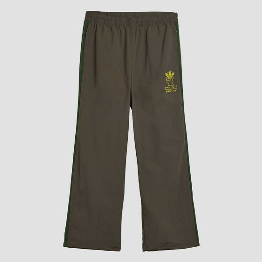 Chocolate track pants with elastic waist, green side stripes, yellow logo patch