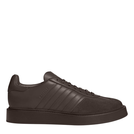 Brown low-top leather sneaker with lace-up front, suede toe, and gum-style sole