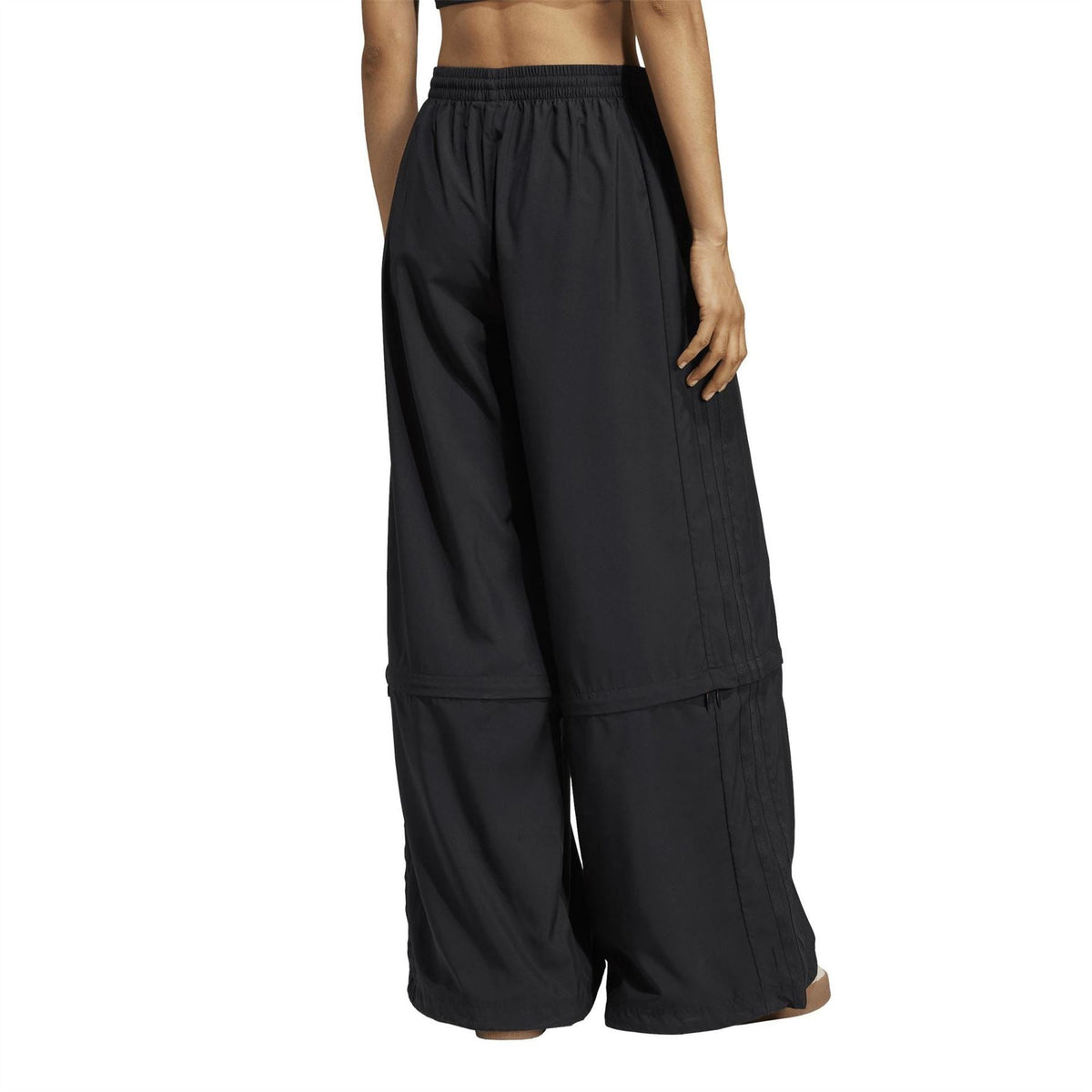 Black wide-leg track pants with elastic waist and side panel seams; full-length legs.