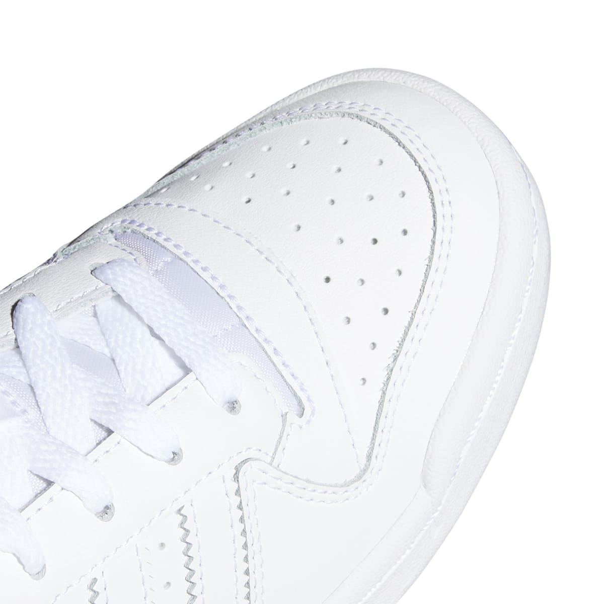 White kids trainer close-up of toe with perforations and lace area stitching