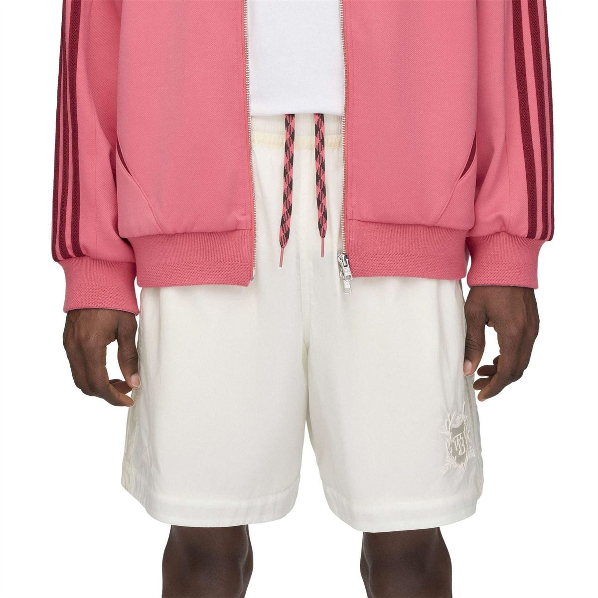 Off-white football shorts with elastic waistband and side seam pockets