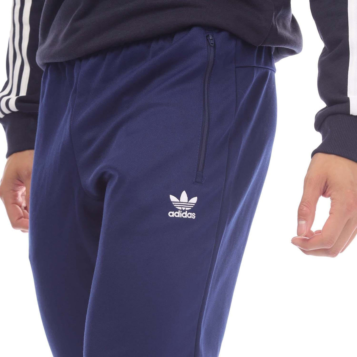 Navy adidas track pants with full-length zip fly and adidas logo