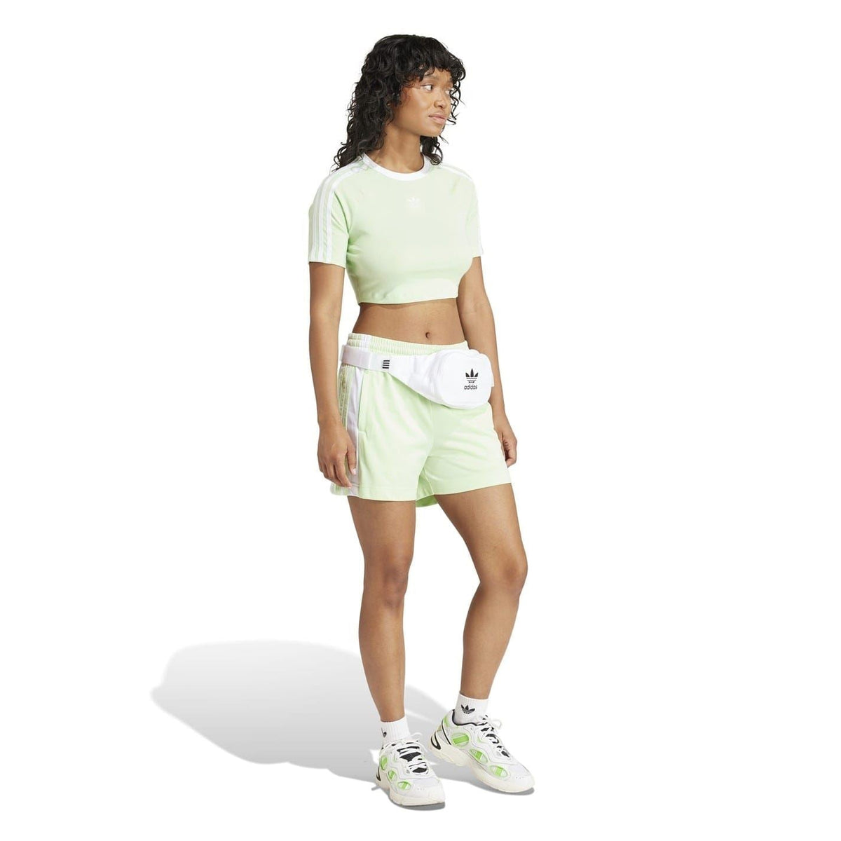 Light green Bermuda shorts with elastic waist and Adidas logo patch on side