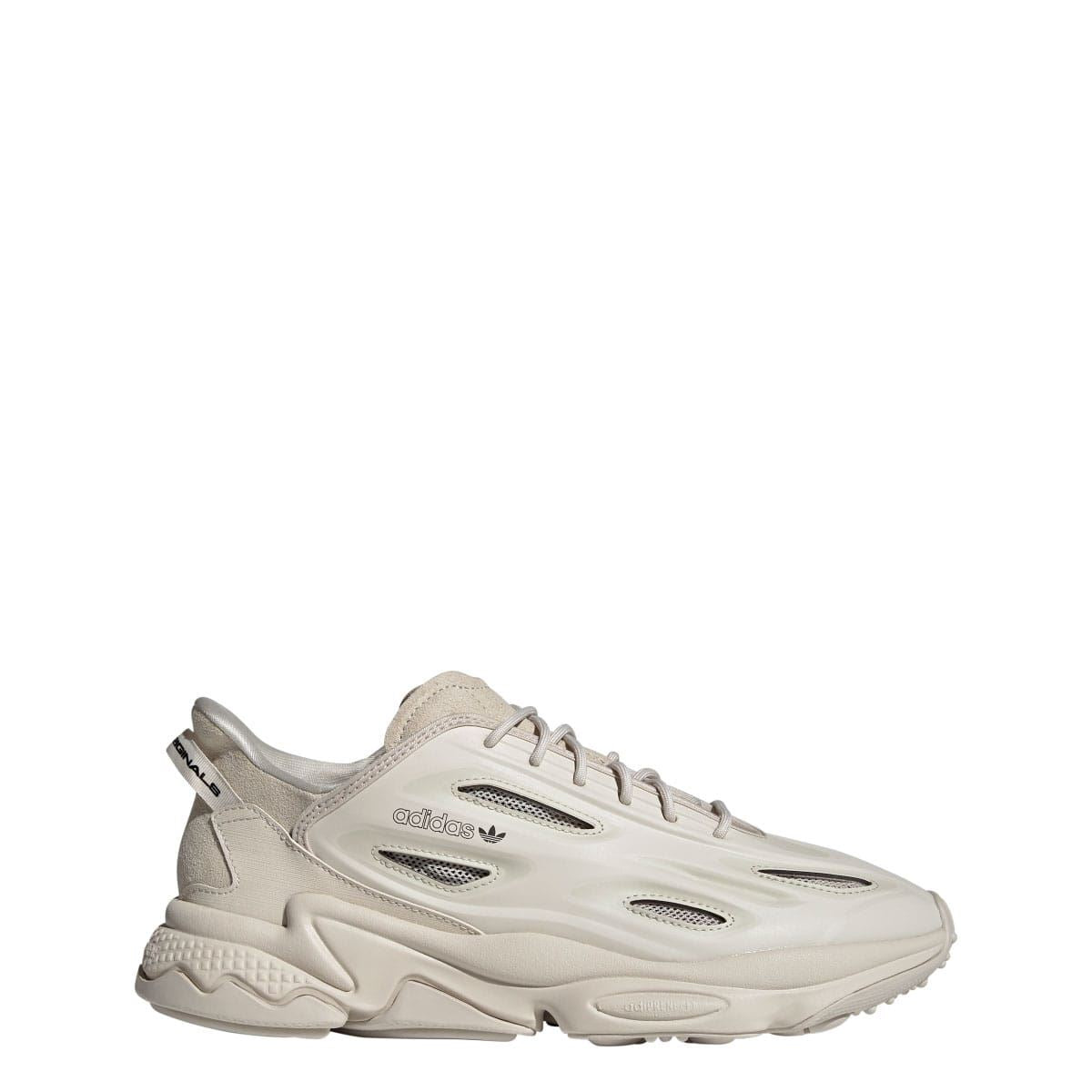 adidas Ozweego trainers in light cream, side profile with lace-up closure and textured trim