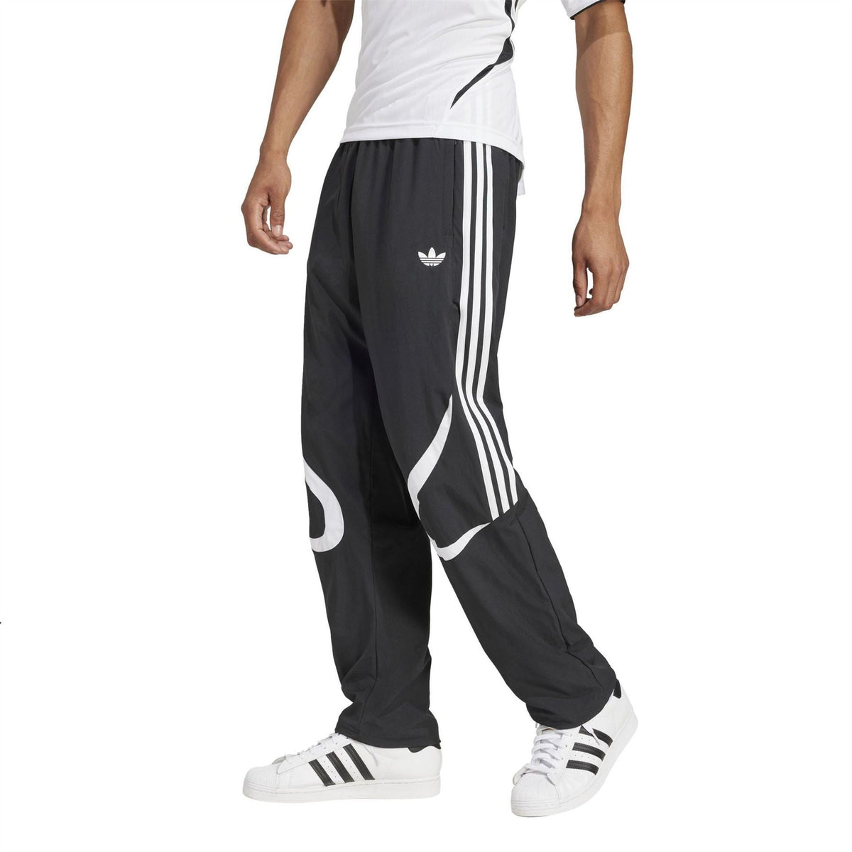 adidas Originals black track pants with white side stripes and tapered legs