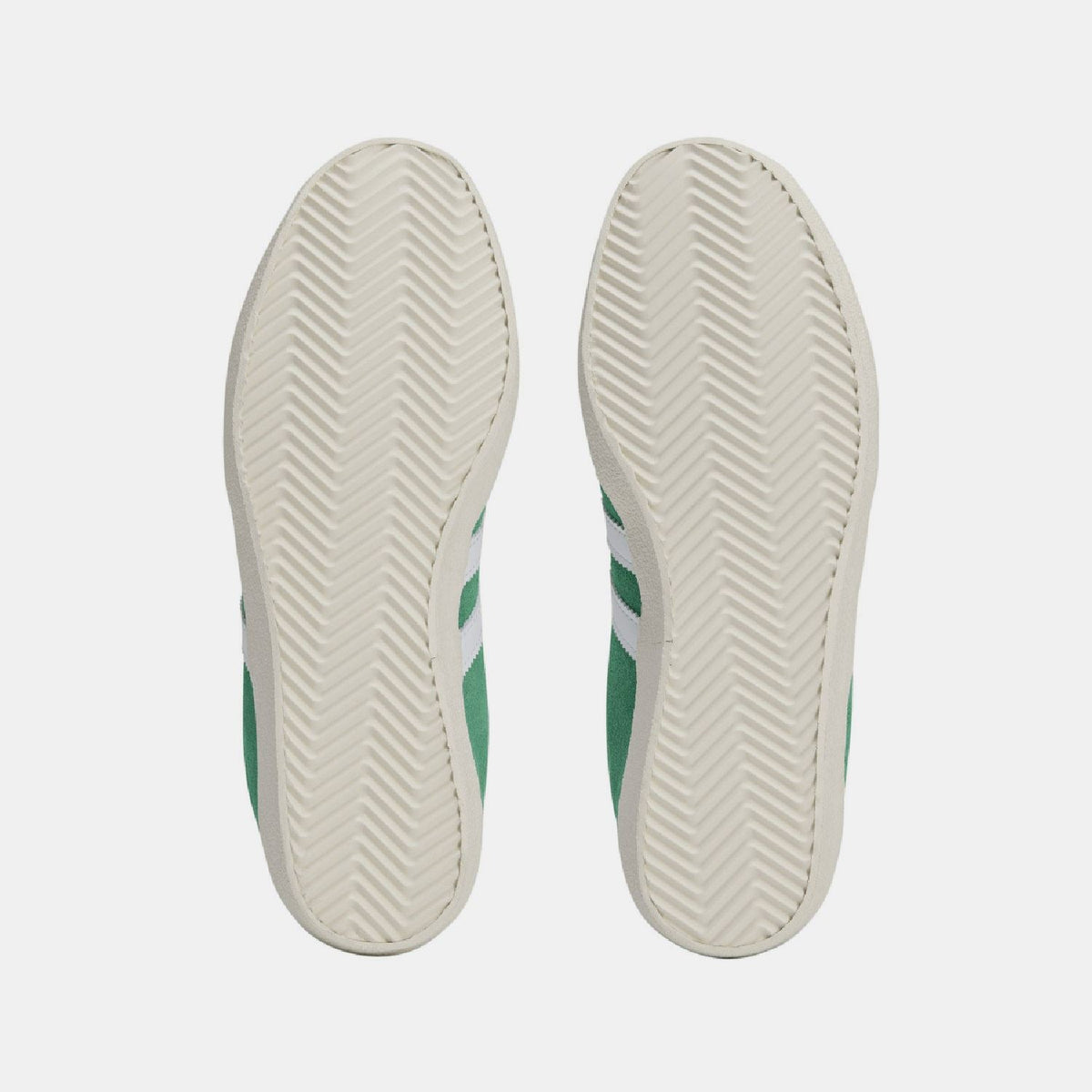 Green-and-white trainer outsole view with textured herringbone tread.
