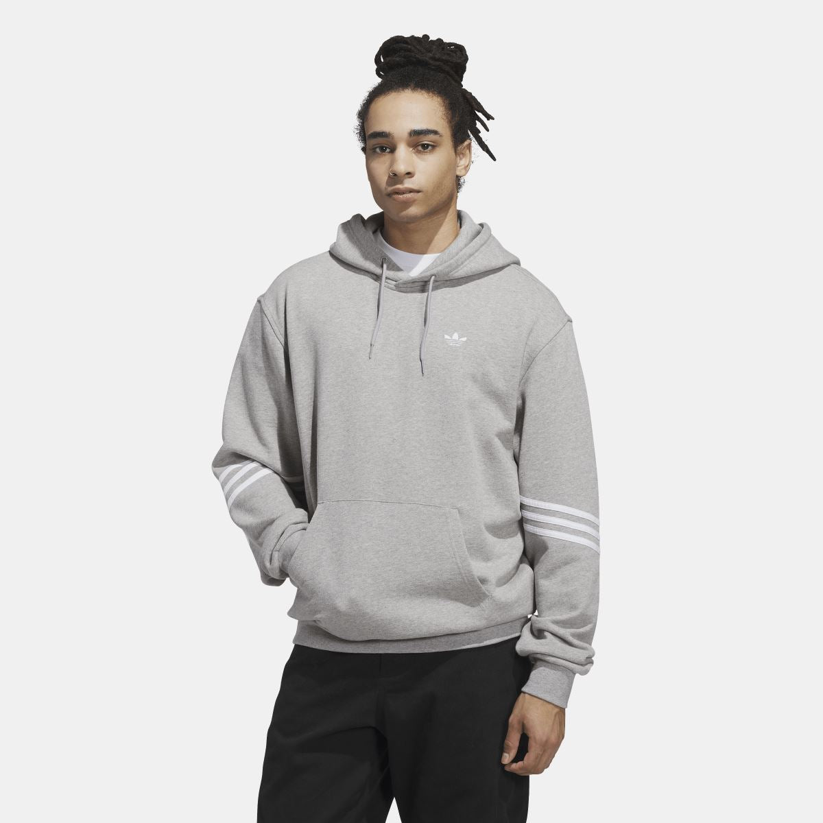 Grey adidas Originals pullover hoodie on model with drawstring hood and chest logo.