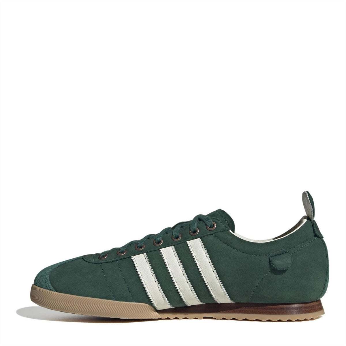 Green low-top sneakers with white adidas stripes, lace-up closure, and gum sole
