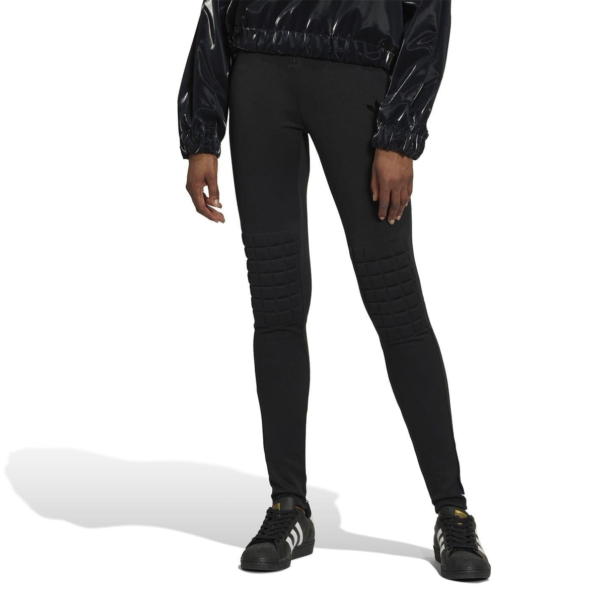 Black performance tights with full-length fit and quilted shin panels