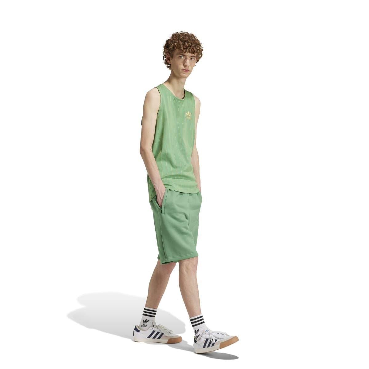 Green adidas trefoil shorts on model, sleeveless top and shorts set