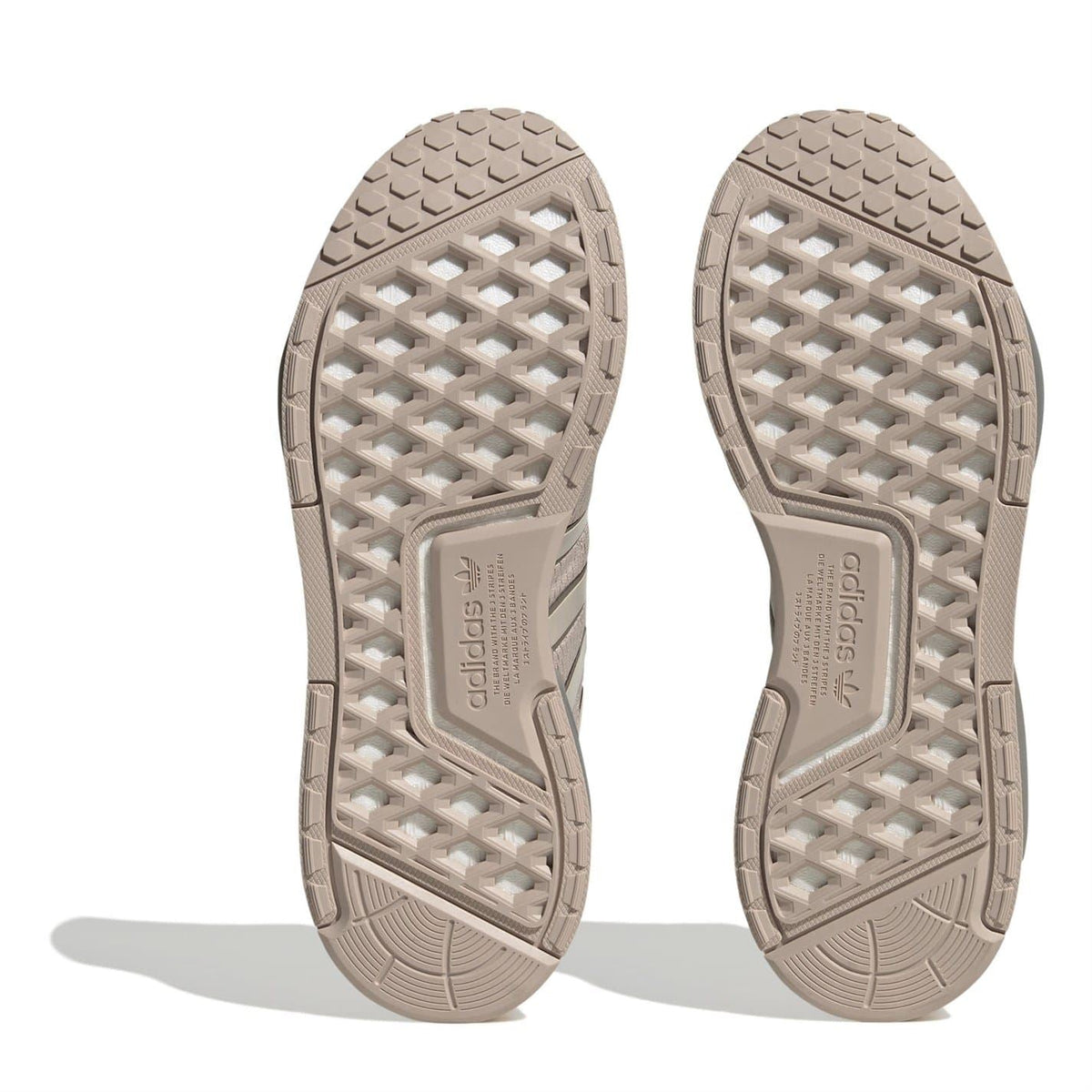 Beige NMD V3 sneaker outsoles with textured grid tread pattern