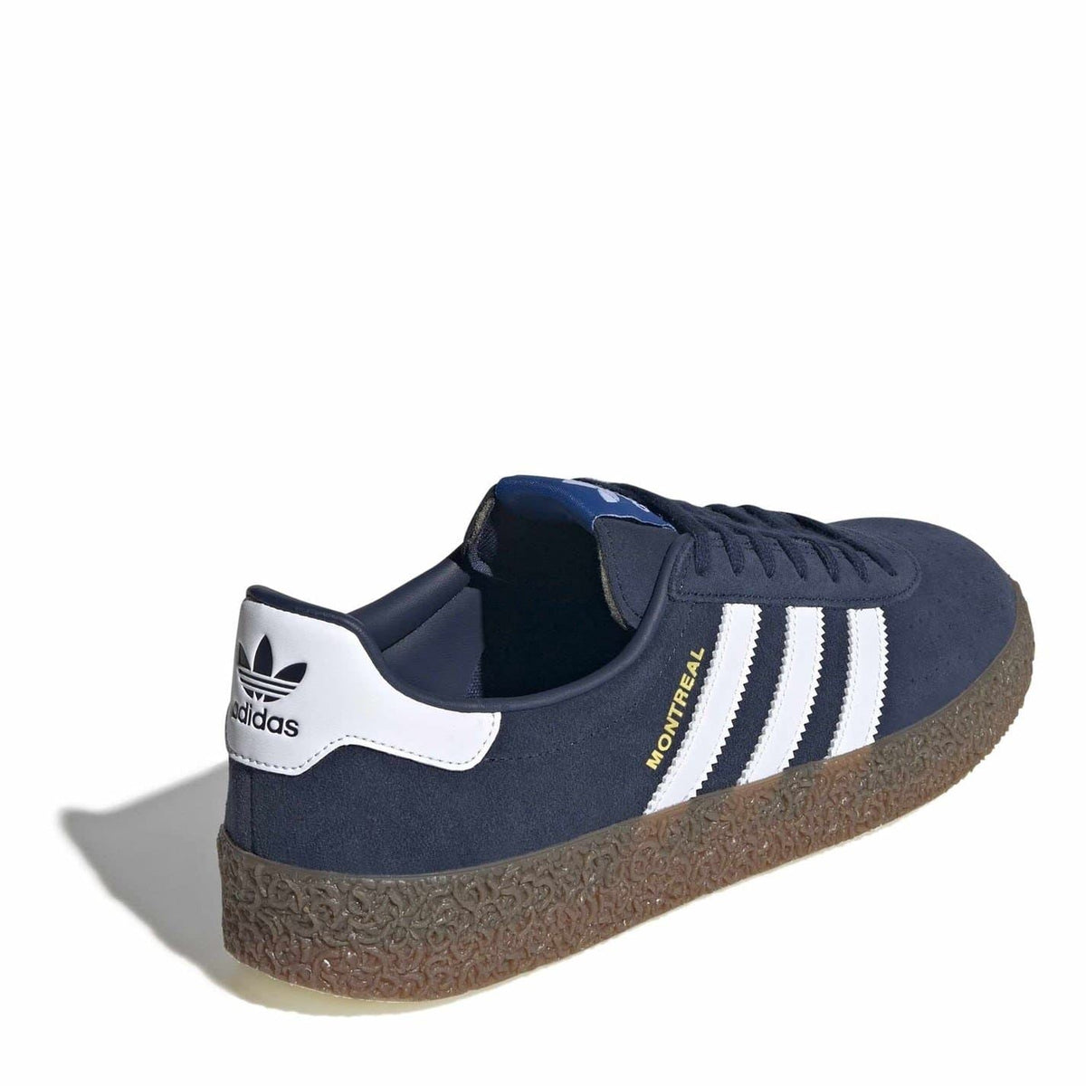Navy suede Montreal trainers with white adidas logo, three stripes, and brown textured sole