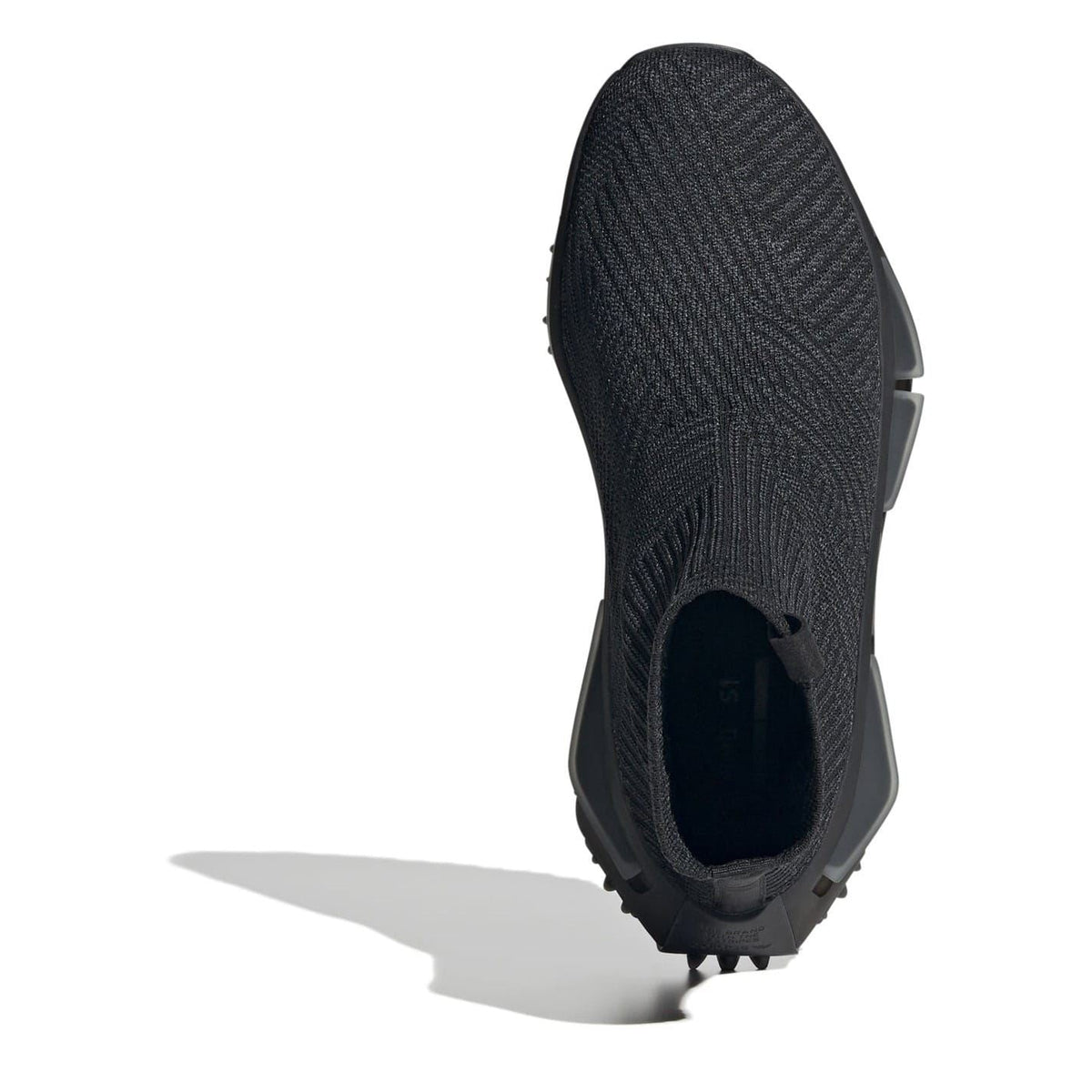 Black knit shoe upper with sock collar and heel tab over treaded base