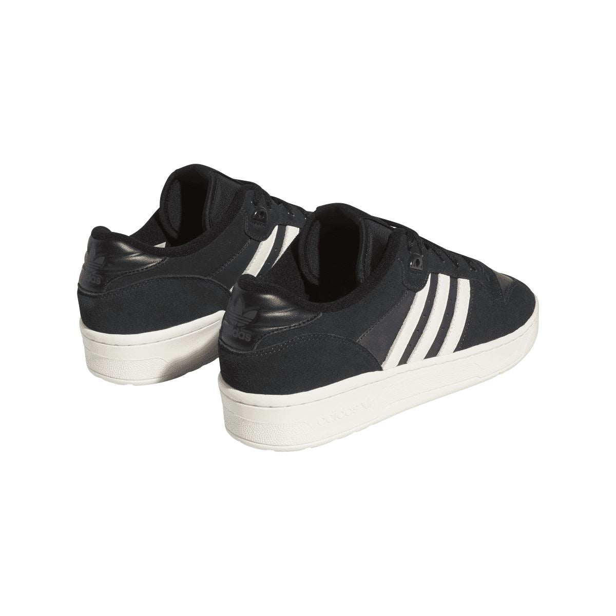 Back view of black low-top trainers with white three stripes and white platform sole