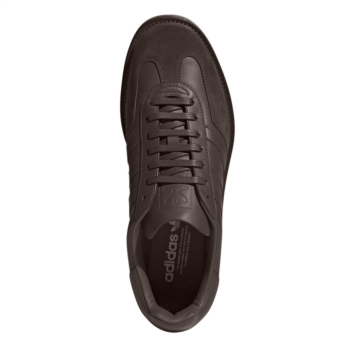 Brown sneaker inside view with lace tongue and adidas logo on footbed