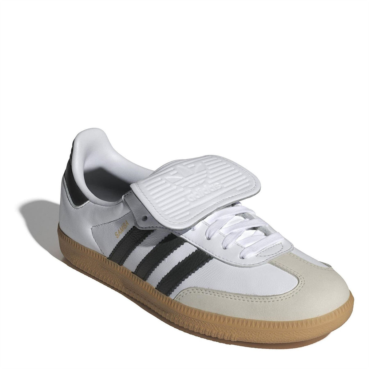 Low-top sneakers with white and light beige panels, black stripes, and tan gum sole.