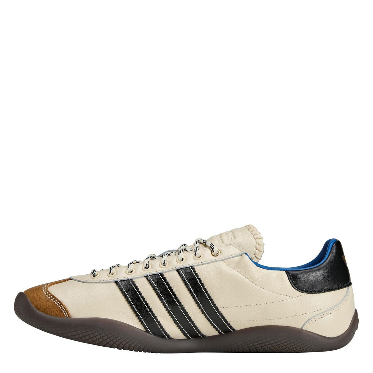 adidas Originals low-top sneakers, cream with black stripes, brown toe, and blue lining