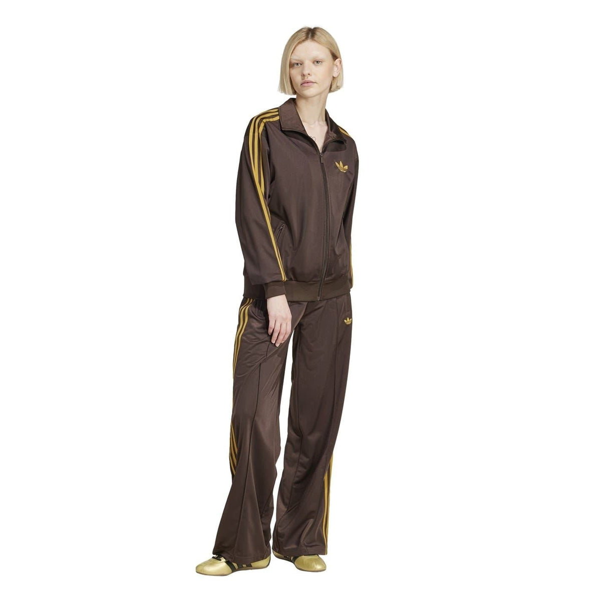 Brown adidas Firebird track pants, full-length with side stripes and trefoil logo