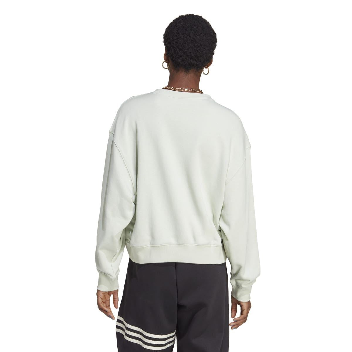 Women’s pale light green crewneck sweatshirt, back view with ribbed cuffs and hem