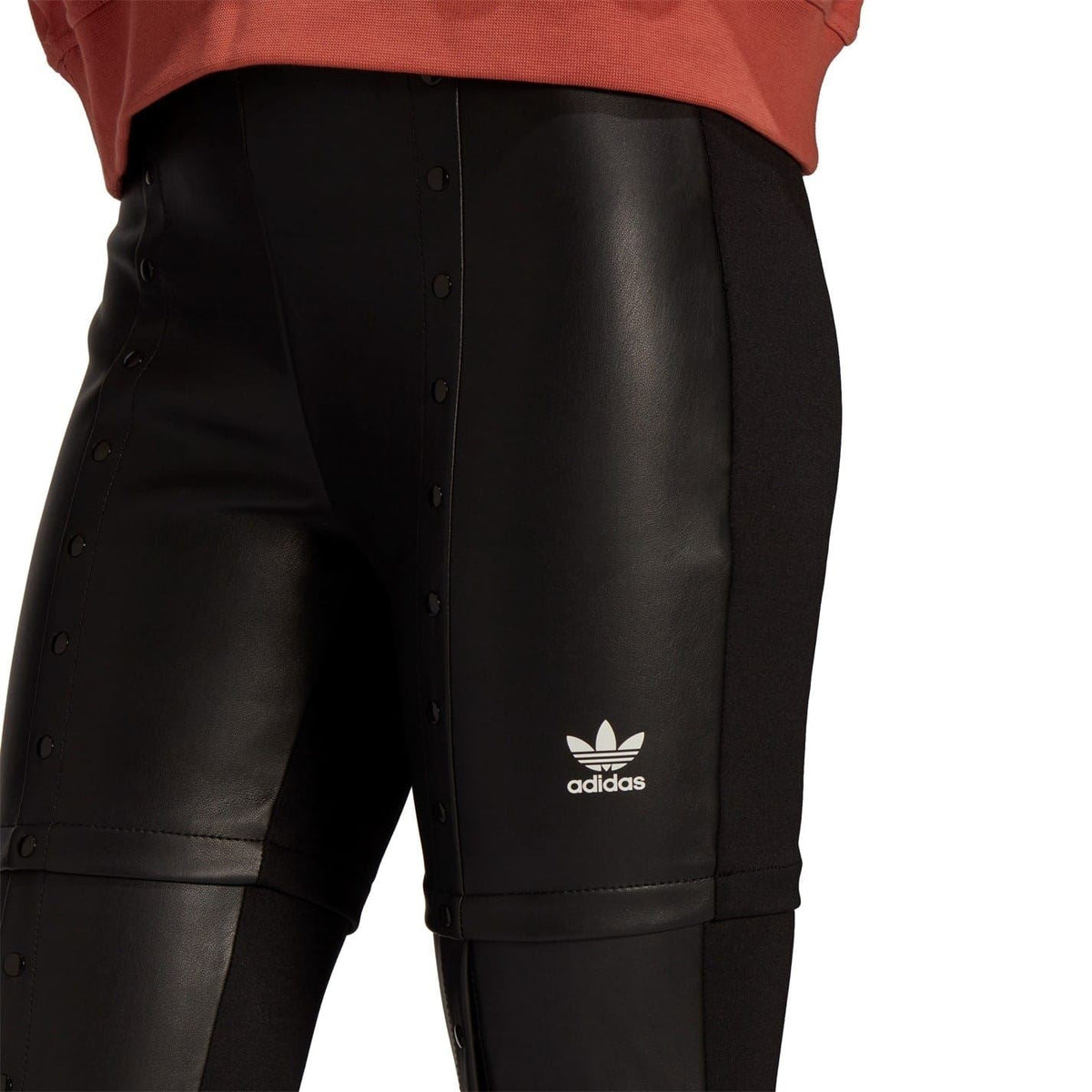 Black faux leather skinny trousers with adidas trefoil logo at right thigh