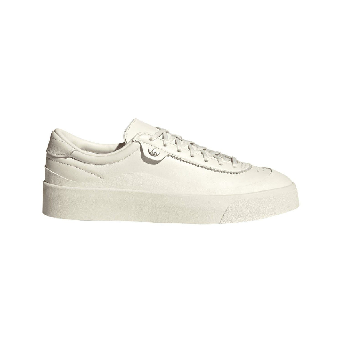 White leather low-top trainers with adidas logo, lace-up front, and thick cupsole.