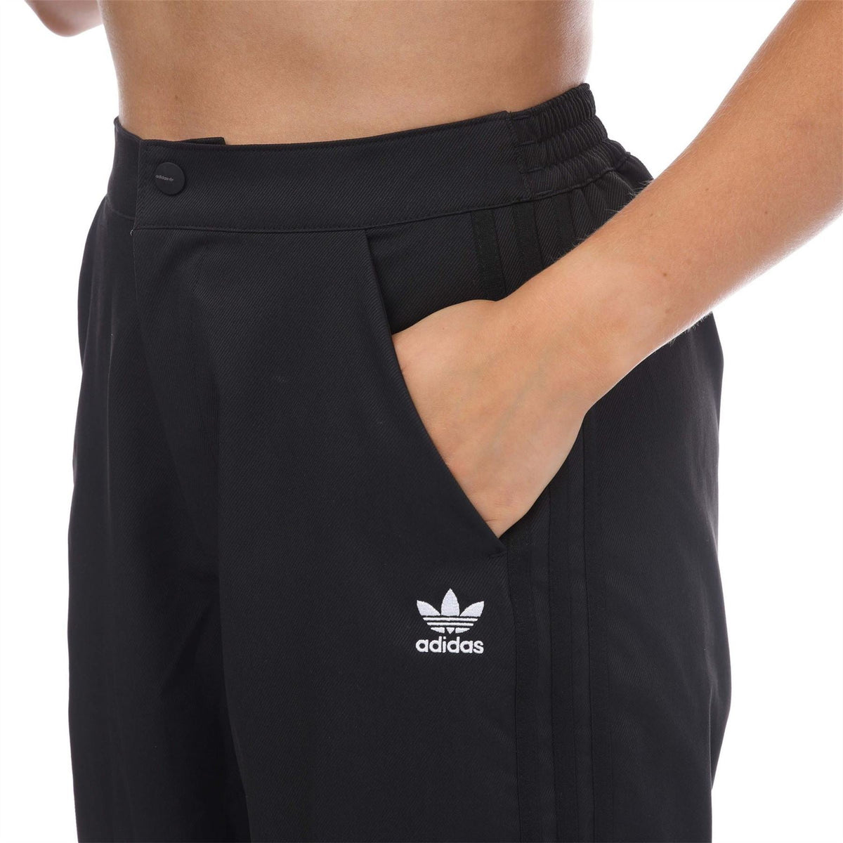 Black adidas track pants with trefoil logo, elastic waistband and front pleats
