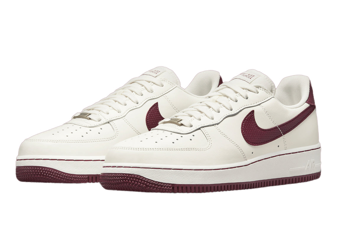 Pair of sail leather low-top sneakers with dark beetroot Swooshes and maroon soles