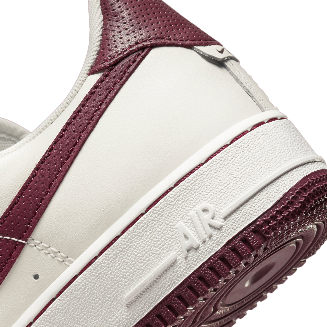 Side close-up: sail leather sneaker with dark beetroot panel and Air embossed on midsole