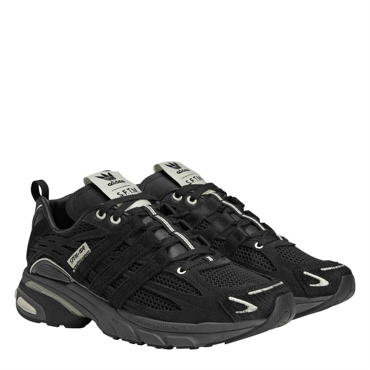 adidas Originals Cushion STFM trainers in black and white with cushioned soles and sporty design, suitable for casual wear
