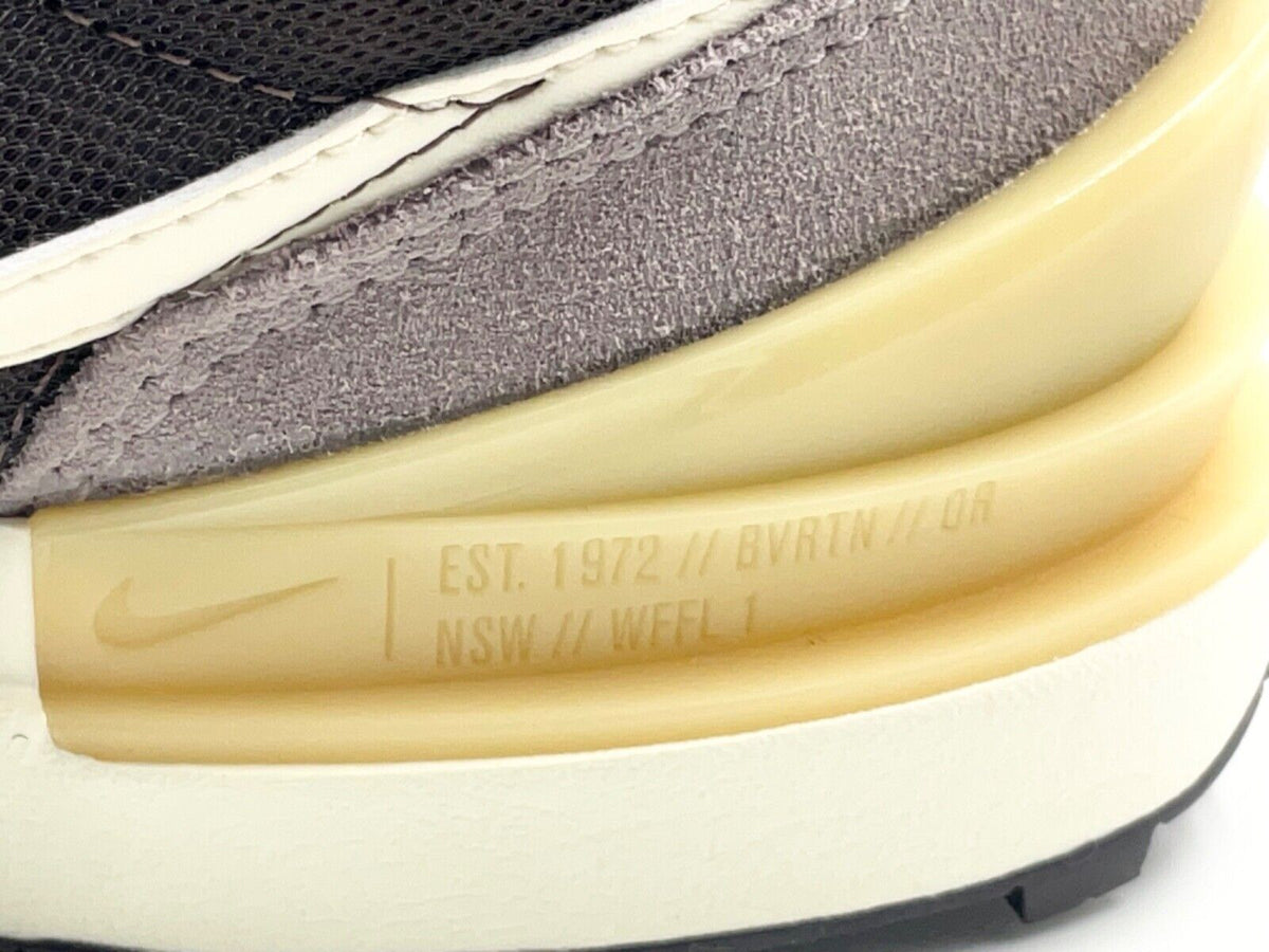 Nike Waffle One midsole close-up, embossed text on pale yellow and white sole
