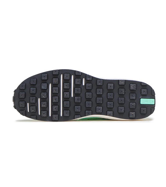 Nike waffle-style rubber outsole with black tread and aqua accent