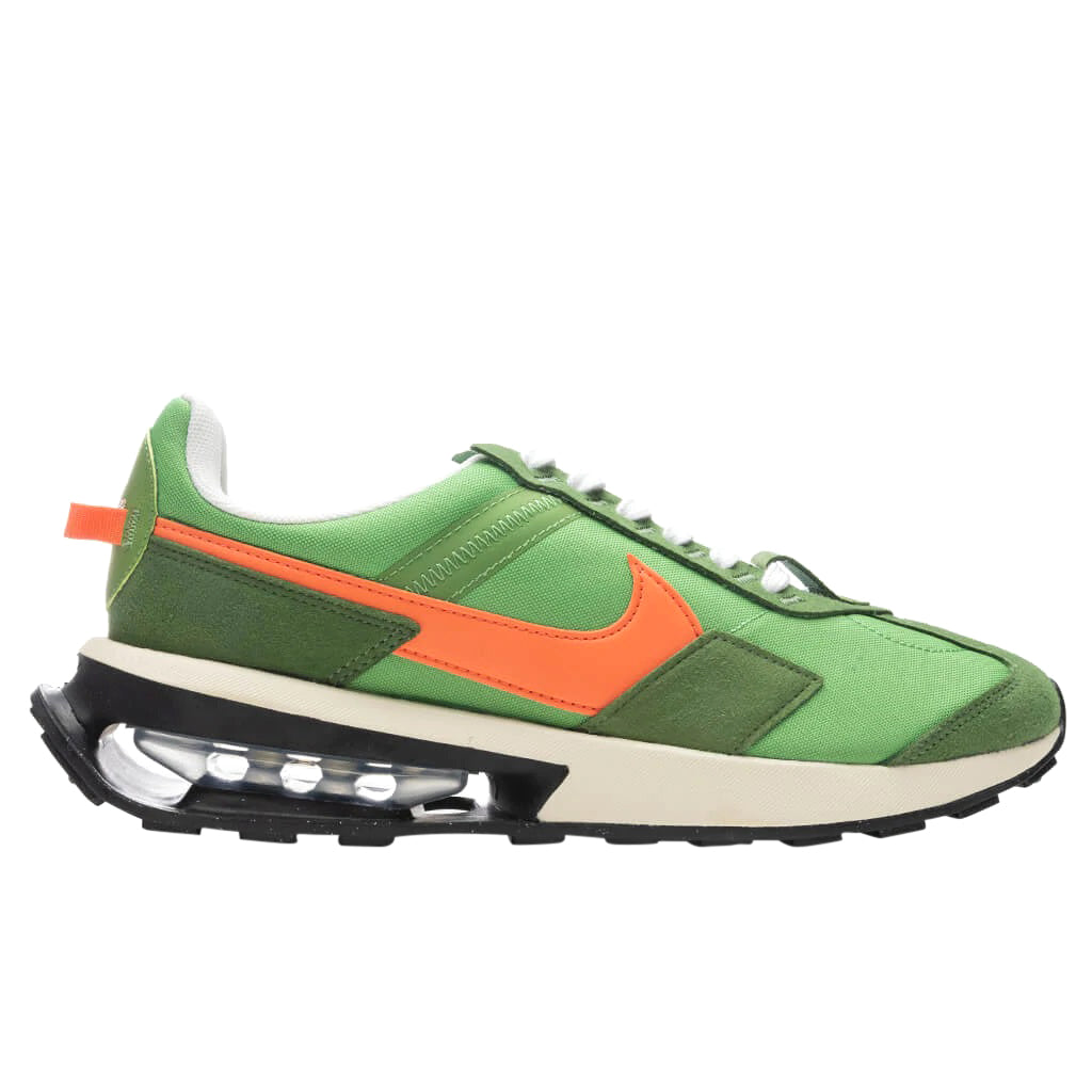 Green Nike Air Max Pre-Day LX sneaker with orange swoosh and black air-cushion sole