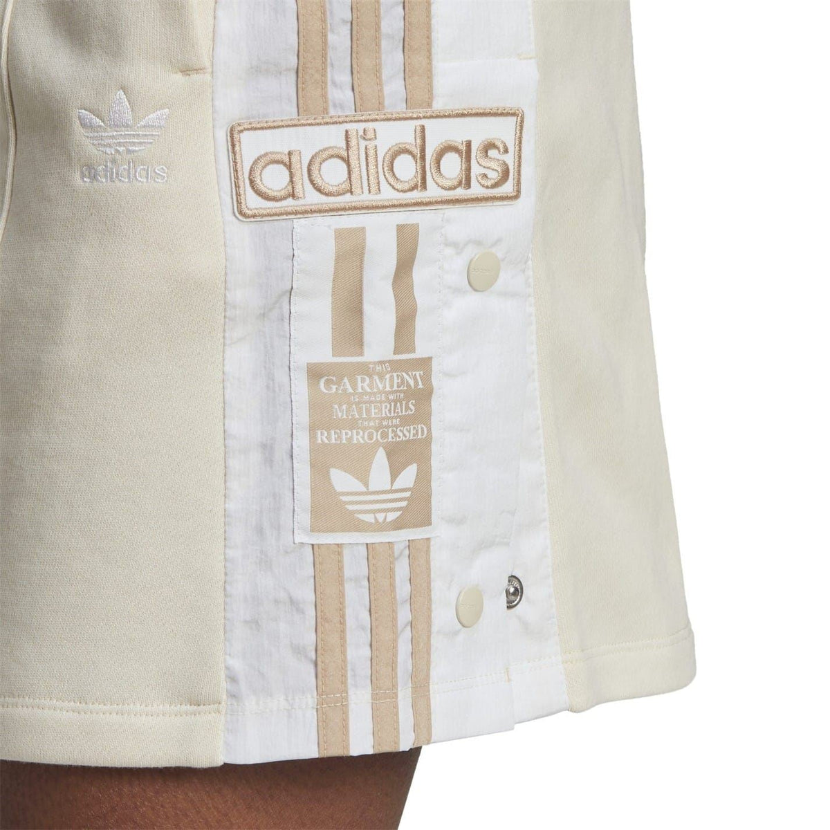 adidas mini skirt close-up with vertical stripe print and garment label patch