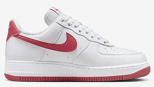 Nike Air Force 1 low-top sneakers, white upper with pink swoosh and lace-up eyelets.