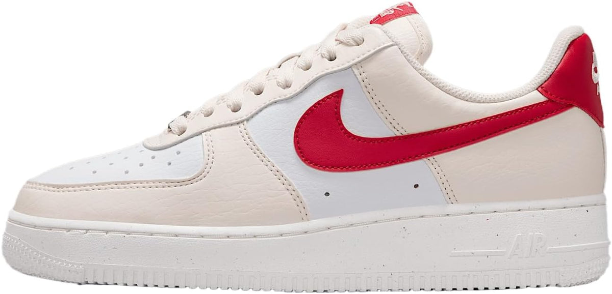 Women's Nike Air Force 1 low-top sneakers in pale ivory with red Swoosh and accents