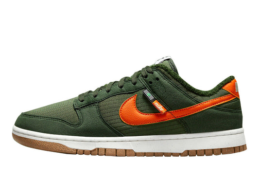 Kids' Nike low-top sneakers in dark green with orange swoosh and white sole