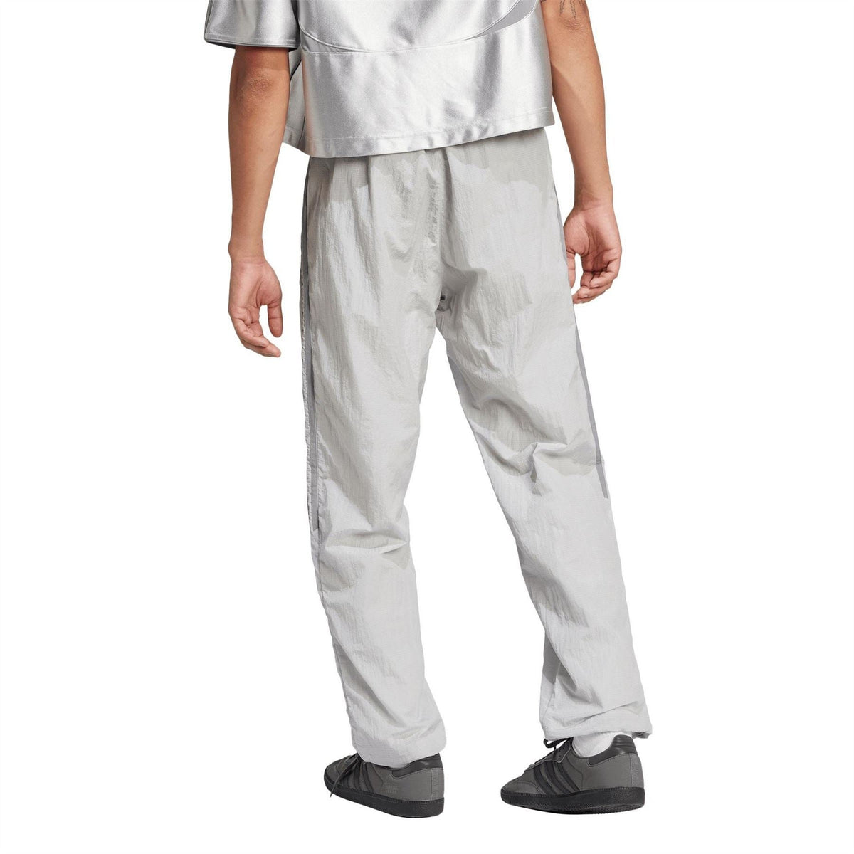 Light grey track pants with tapered legs, elastic ankle cuffs, and adidas logo