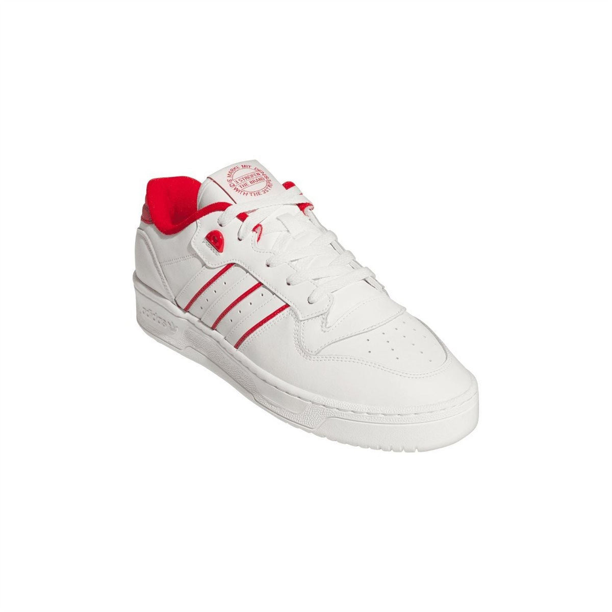 White low-top trainers with red heel collar, three stripe panel, and lace-up.