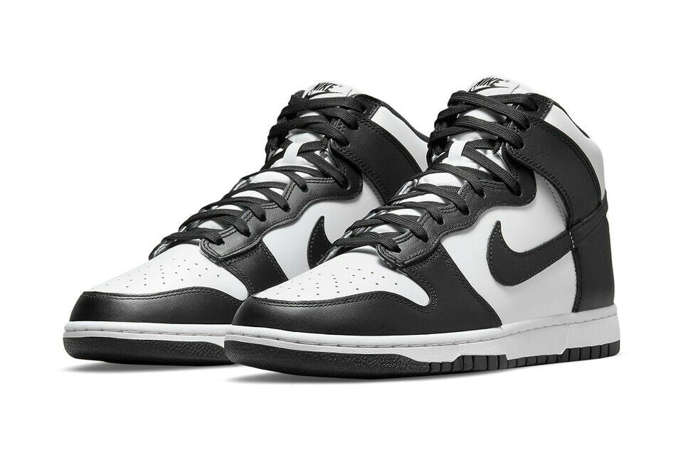Pair of Nike Dunk high-top sneakers in white and black with black laces.