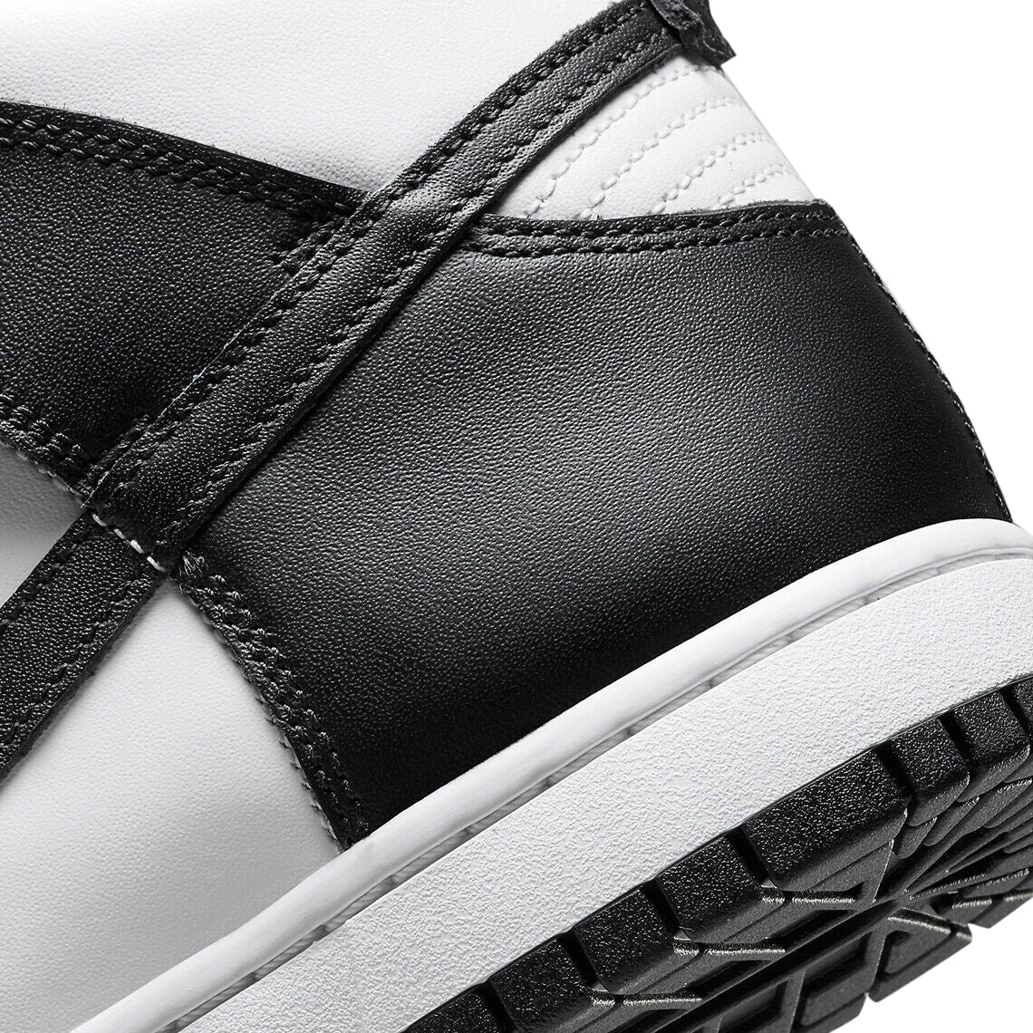 Nike Dunk high-top close-up: black and white leather upper with white midsole.