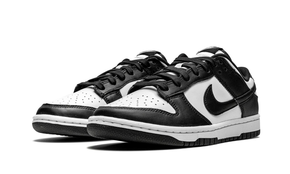 Nike Dunk Low sneakers, black and white leather uppers with perforations, laces, and Swoosh.