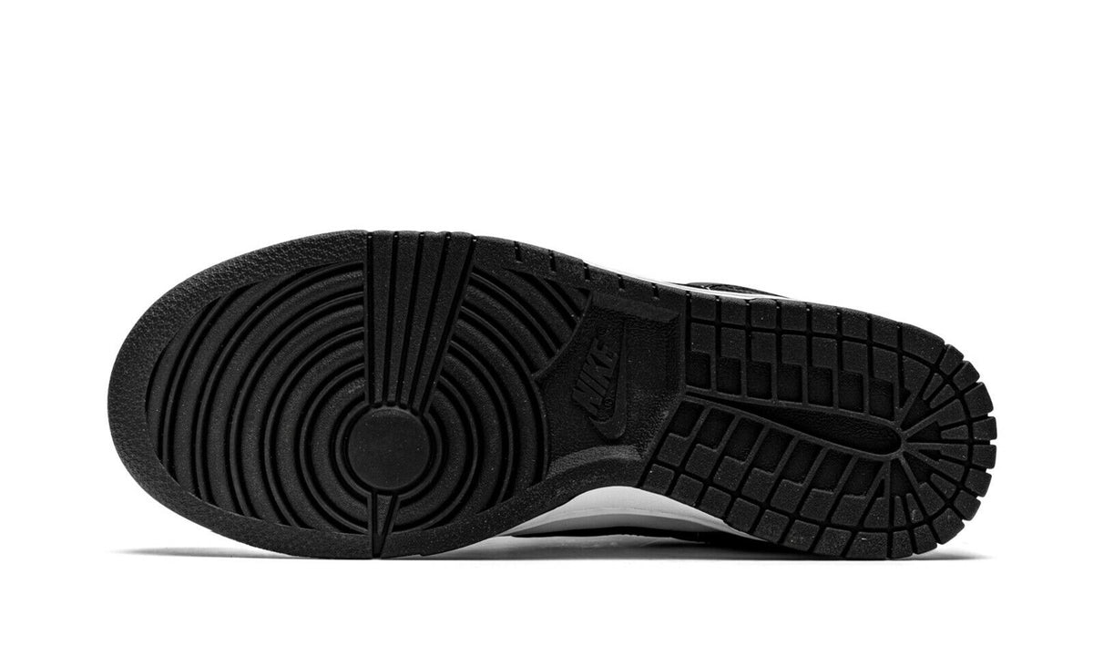 Nike Dunk Low rubber outsole with traction tread, black outsole, white midsole.