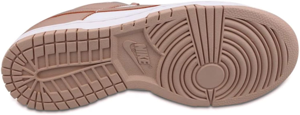 Women's Nike Dunk Low outsole view with brown rubber tread and circular traction pattern