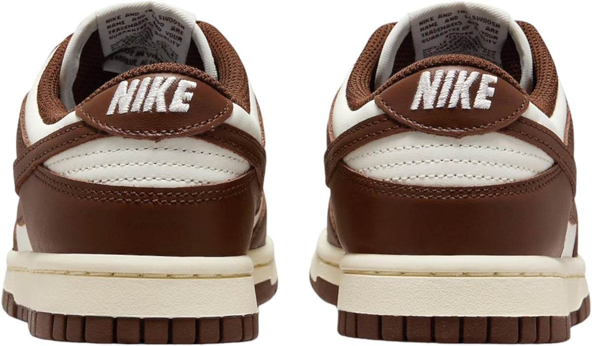 Women’s Nike Dunk Low sneakers, rear view with padded collar and Nike logo on heel.