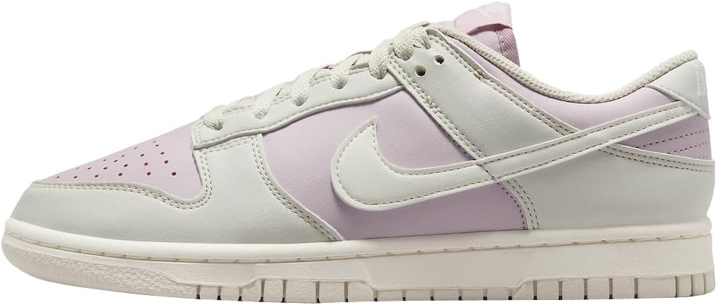 Women's Nike Dunk Low sneakers, light bone with lilac swoosh and heel tab.