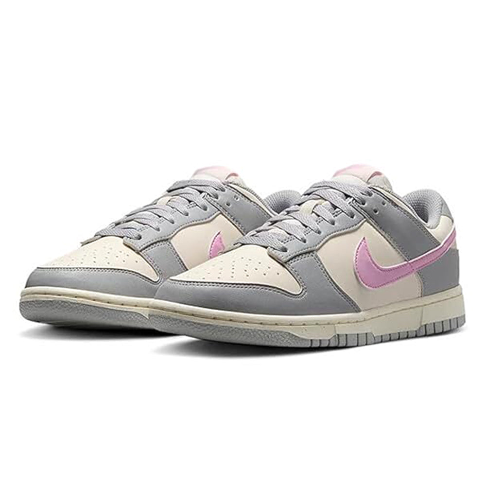 Pair of Nike Dunk Low sneakers with grey, beige, and pink accents