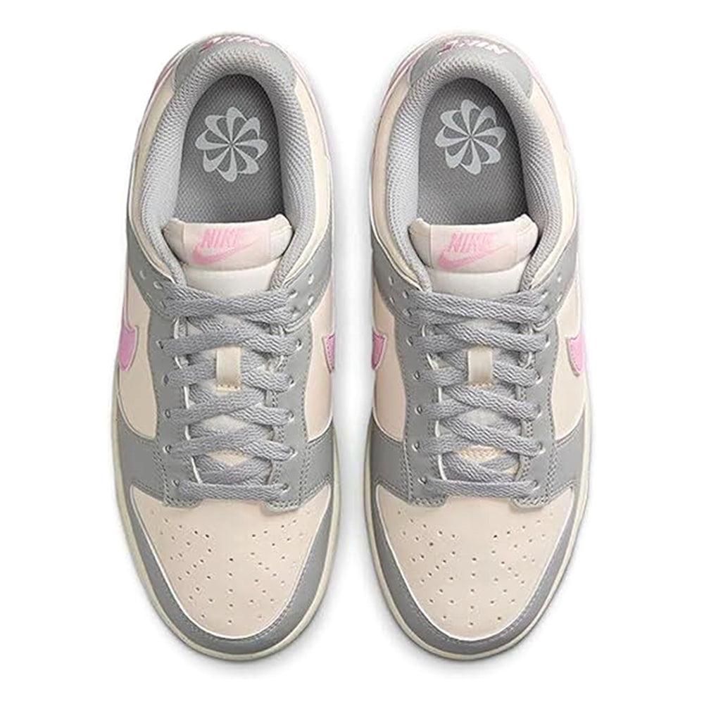 Nike Dunk Low sneakers with grey tongue lining and pink logo details