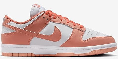 Women's Nike Dunk Low low-top with coral laces, white base, and orange Swoosh